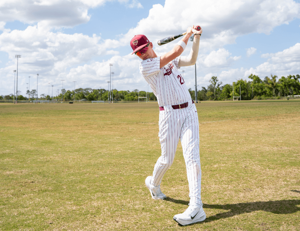 BaseballClub FSU Baseball Club Member swings bat in field