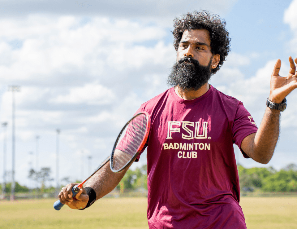 BadmintonClub FSU Badminton Club Member poses with badminton racquet